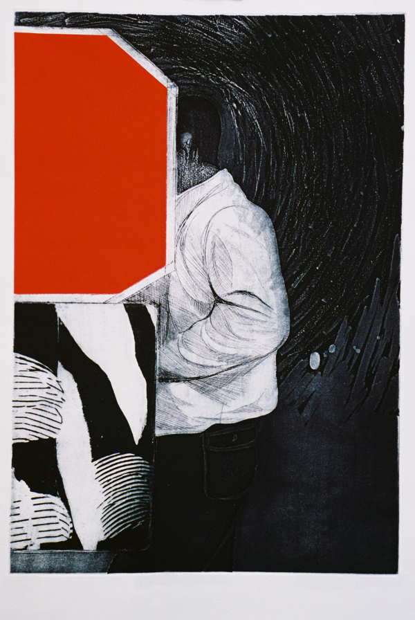 a man standing in front of a red rectangular object